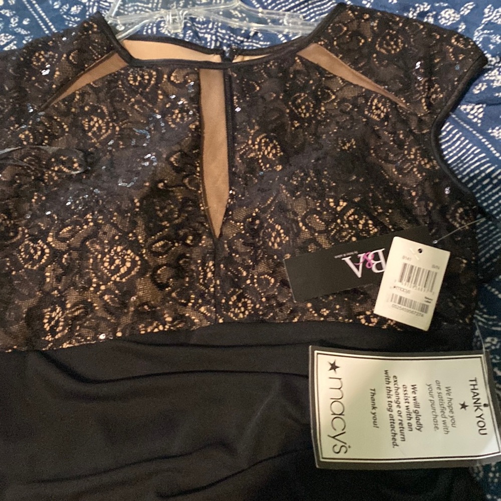 Cute little black dress. Full length zipper w/sheer panels without exposing.